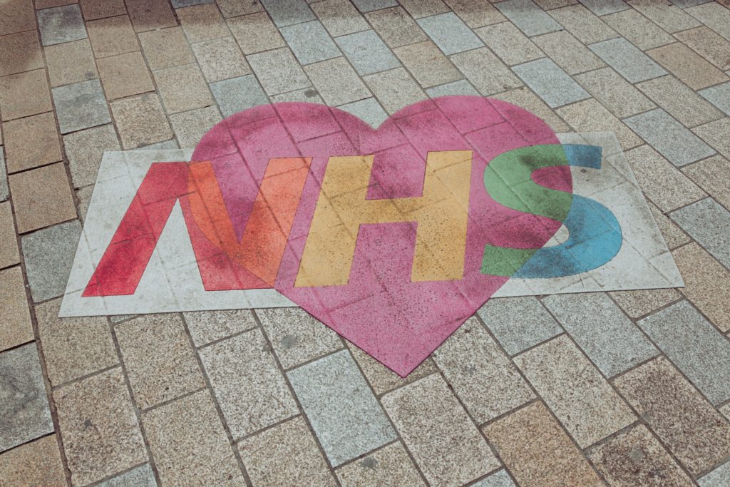 Purple and pink NHS logo